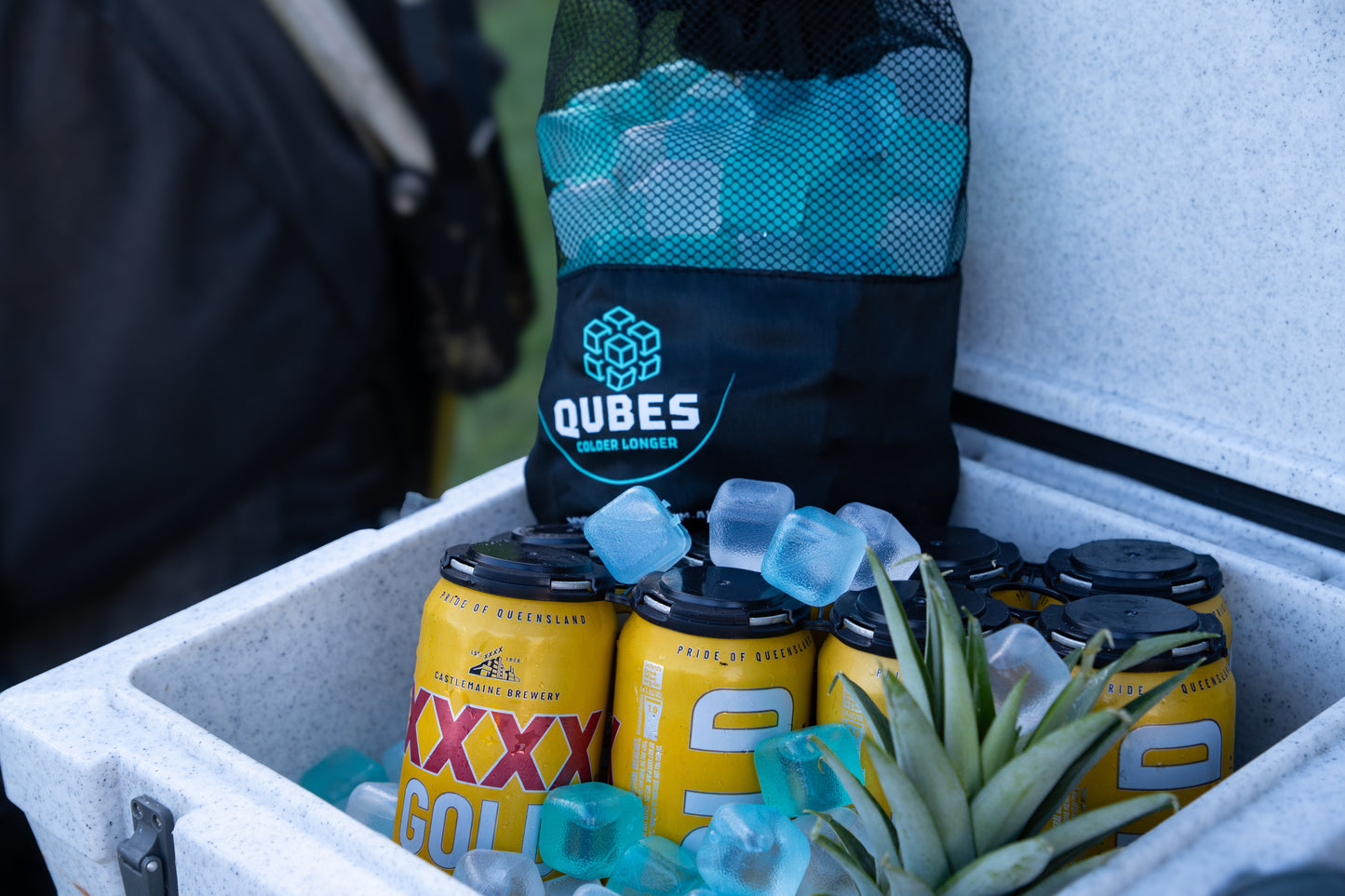 Cooler packed with reusable ice cube bags and drinks for an outdoor trip