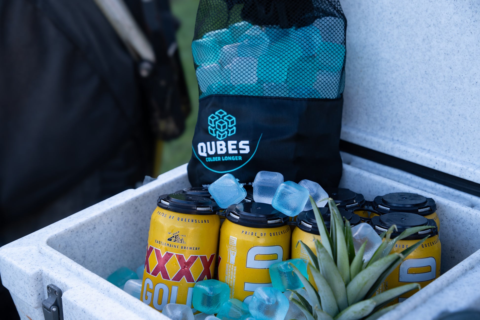 Cooler packed with reusable ice cube bags and drinks for an outdoor trip